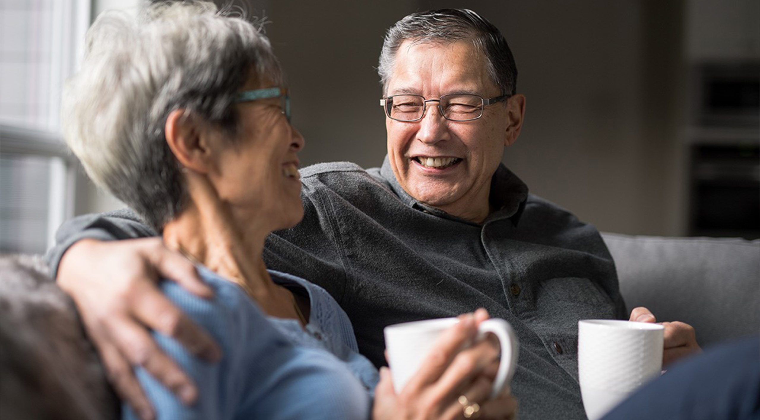 senior couple smiling with coffee